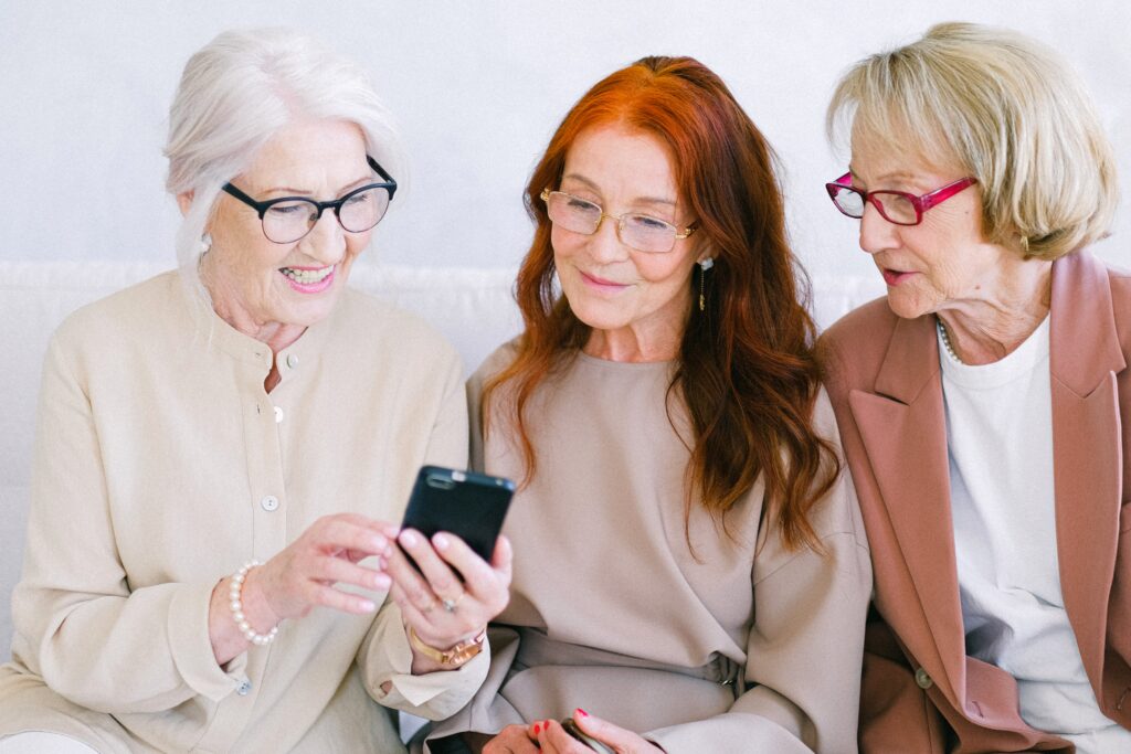 Three women looking at a cell phone screen